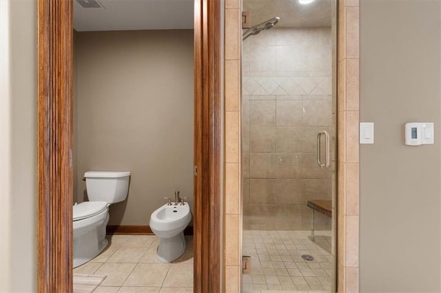 full bath with toilet, a bidet, a shower stall, tile patterned flooring, and baseboards