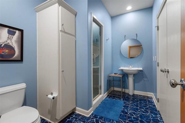 bathroom featuring a stall shower, baseboards, toilet, and recessed lighting