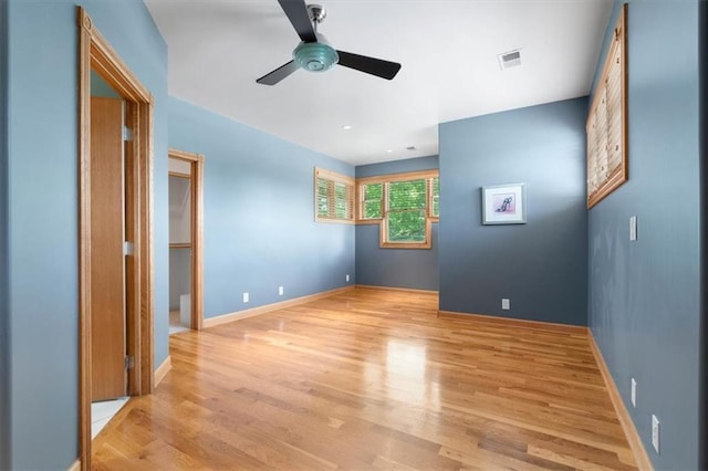 unfurnished bedroom with light wood finished floors, visible vents, and baseboards