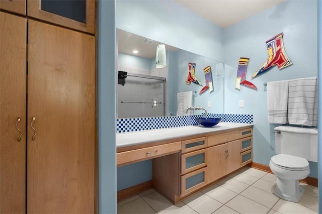 full bath with toilet, a stall shower, vanity, tile patterned flooring, and baseboards