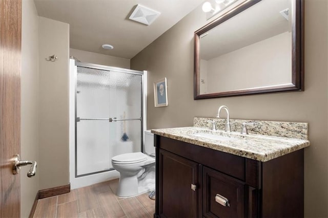 bathroom featuring a stall shower, visible vents, vanity, and toilet