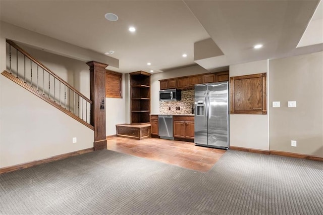 kitchen with brown cabinetry, stainless steel appliances, light countertops, and ornate columns