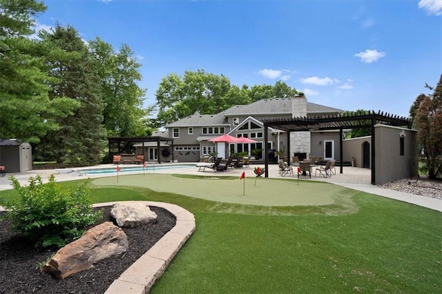 rear view of property with a patio area, an outdoor pool, and a pergola