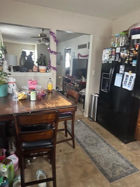 dining space with a ceiling fan and visible vents