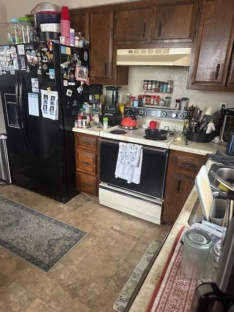 kitchen with black fridge with ice dispenser, light countertops, dark brown cabinets, range hood, and white range with electric cooktop