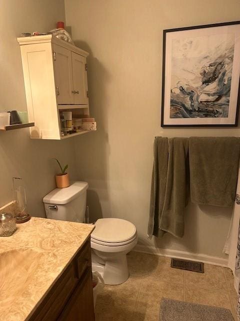 bathroom with visible vents, toilet, vanity, tile patterned flooring, and baseboards