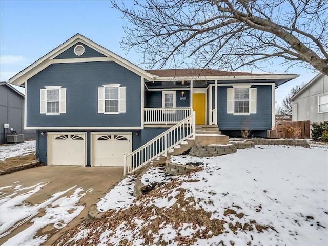 ranch-style house with concrete driveway, an attached garage, and central AC unit