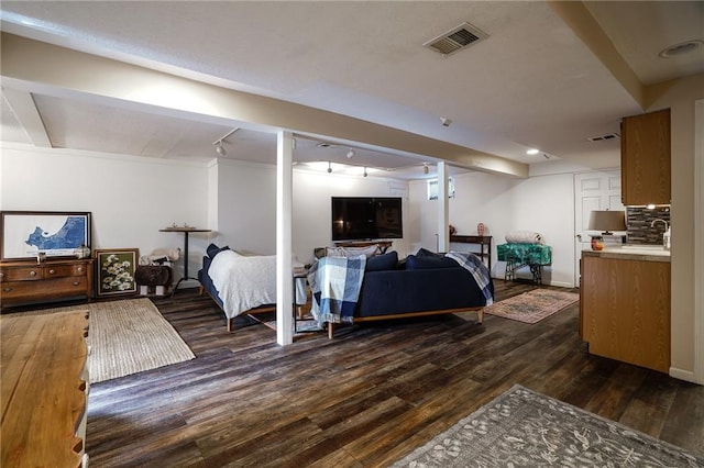 bedroom featuring dark wood finished floors, visible vents, and baseboards