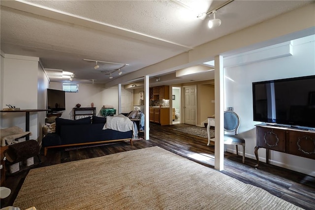 bedroom featuring dark wood-type flooring and rail lighting