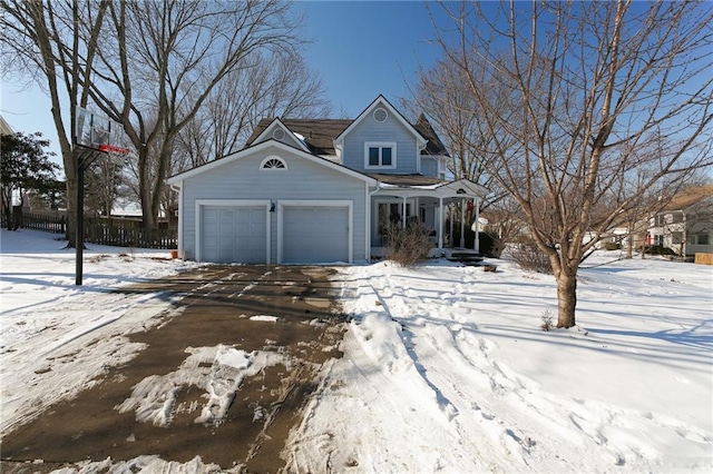 view of front facade featuring a garage and fence