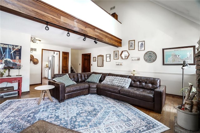 living room with visible vents, stairs, beam ceiling, dark wood-style floors, and rail lighting