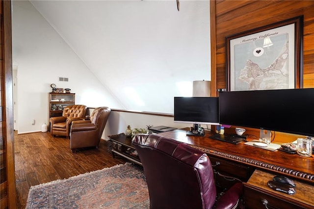 home office featuring lofted ceiling, visible vents, and dark wood-type flooring