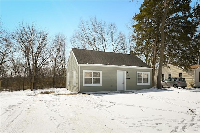 view of front of property with a garage and a shingled roof