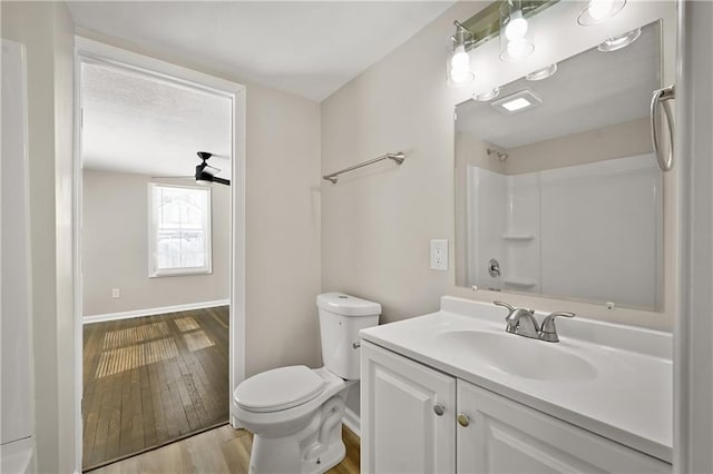 full bath featuring baseboards, vanity, toilet, and wood finished floors