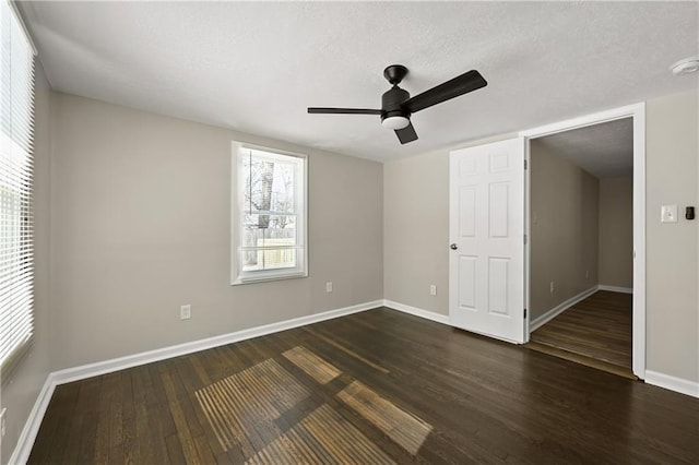 unfurnished bedroom with dark wood-style floors, ceiling fan, and baseboards