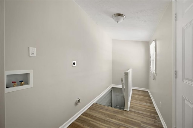 laundry room with laundry area, baseboards, wood finished floors, hookup for a washing machine, and electric dryer hookup