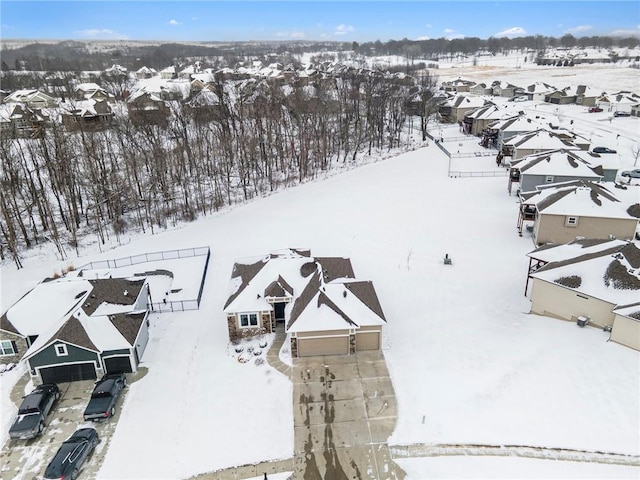 snowy aerial view featuring a residential view