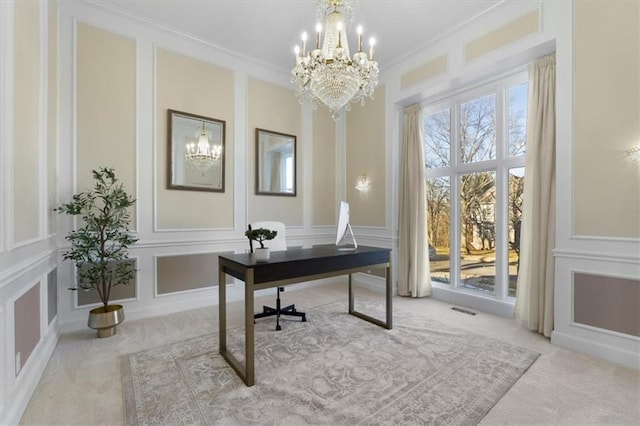 carpeted office space with crown molding, visible vents, a decorative wall, and an inviting chandelier