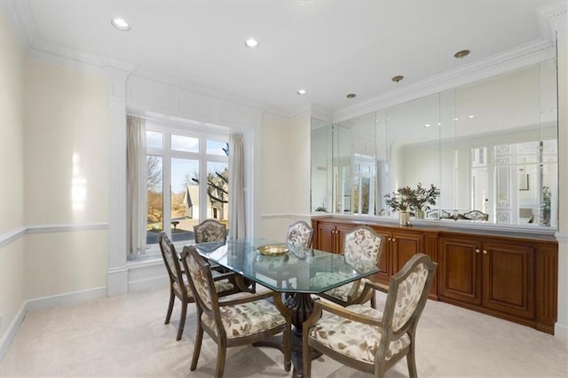 dining space featuring recessed lighting, baseboards, crown molding, and light colored carpet