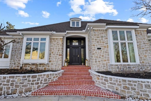 entrance to property with stone siding