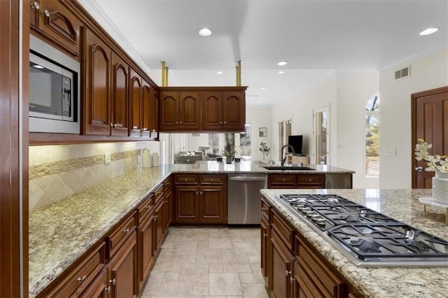 kitchen featuring stainless steel appliances, a sink, visible vents, ornamental molding, and light stone countertops