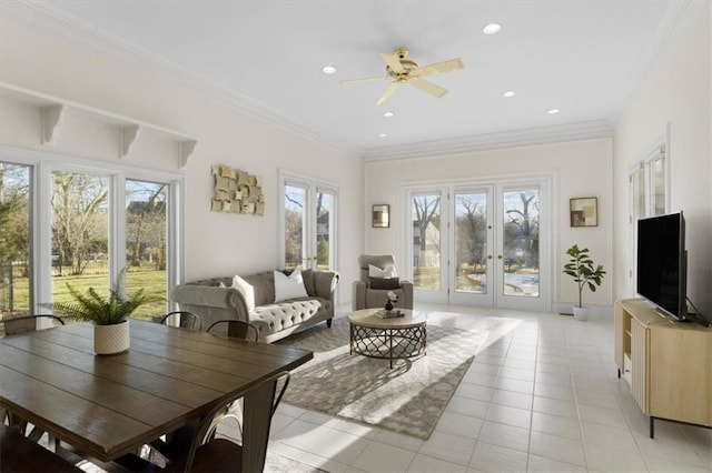 sunroom / solarium with a ceiling fan and french doors