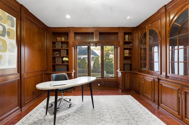 unfurnished office featuring built in shelves, recessed lighting, and dark wood finished floors