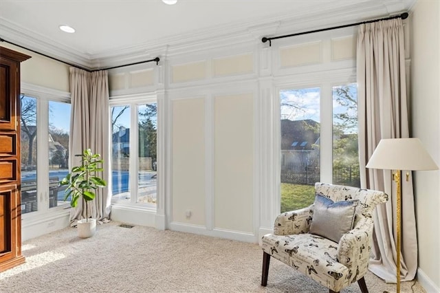 sitting room featuring carpet and ornamental molding