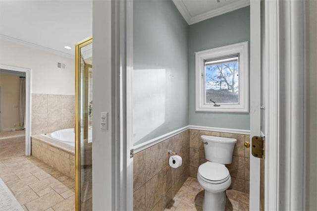 bathroom with toilet, visible vents, tile walls, ornamental molding, and tiled tub