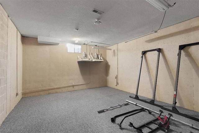 interior space featuring a textured ceiling, carpet, and visible vents