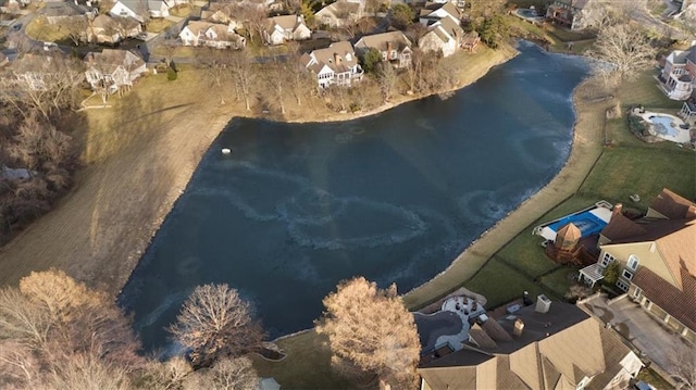 drone / aerial view with a water view and a residential view