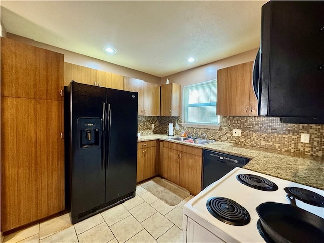 718 Oakland Ave, Kansas City, KS 66101 - kitchen with black appliances, brown cabinets, a sink, and decorative backsplash