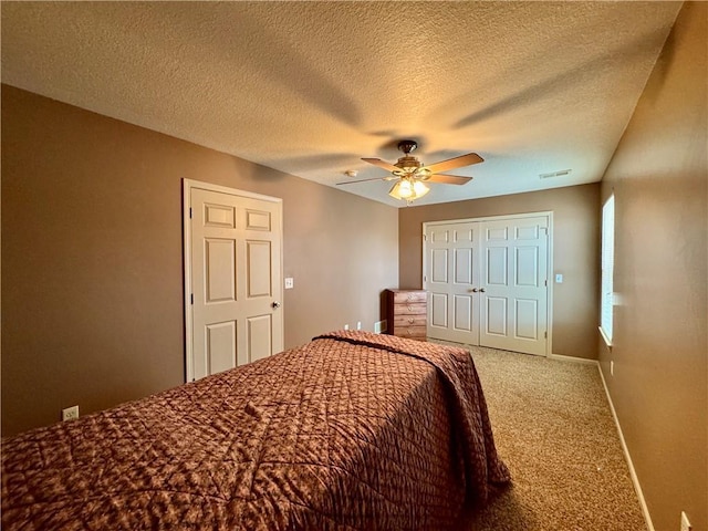 718 Oakland Ave, Kansas City, KS 66101 - carpeted bedroom featuring a textured ceiling, a ceiling fan, visible vents, baseboards, and a closet
