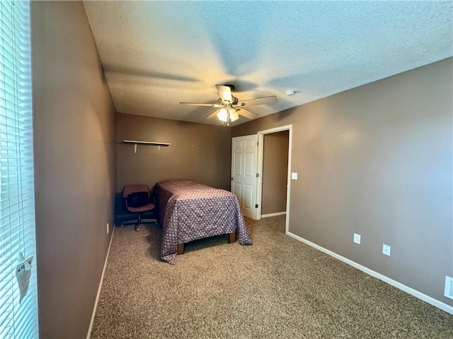 718 Oakland Ave, Kansas City, KS 66101 - unfurnished bedroom with carpet floors, ceiling fan, a textured ceiling, and baseboards