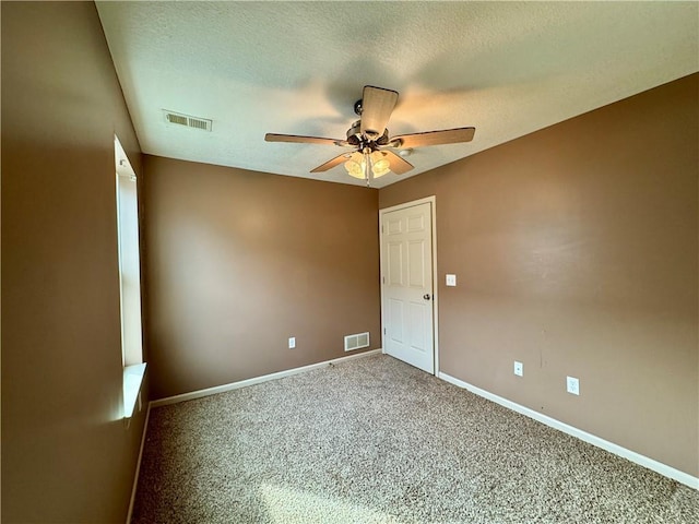 718 Oakland Ave, Kansas City, KS 66101 - carpeted empty room featuring a ceiling fan, visible vents, a textured ceiling, and baseboards