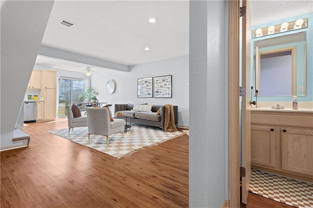 living room featuring recessed lighting, visible vents, ceiling fan, and light wood finished floors