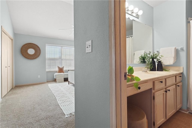 full bathroom featuring ceiling fan, baseboards, and vanity