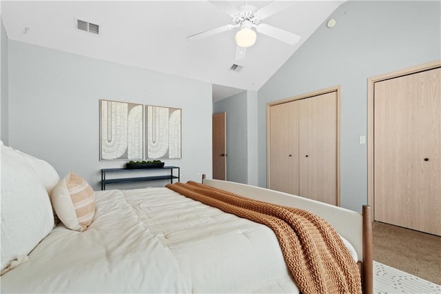 bedroom with a ceiling fan, carpet flooring, visible vents, and multiple closets