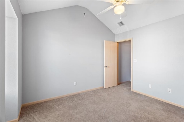 unfurnished room with lofted ceiling, light colored carpet, visible vents, ceiling fan, and baseboards