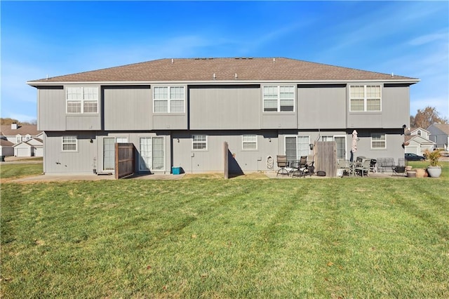 rear view of property featuring a yard and a patio