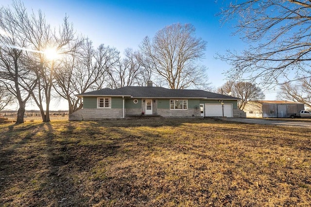 ranch-style house featuring a garage and a chimney