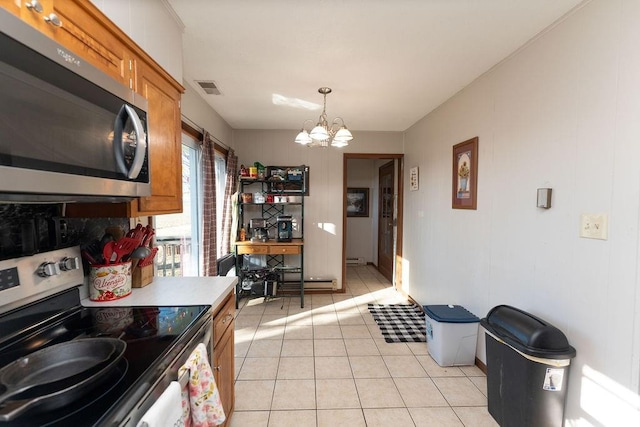 kitchen featuring visible vents, appliances with stainless steel finishes, brown cabinets, a chandelier, and light tile patterned flooring