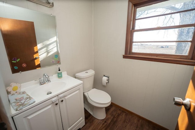 bathroom featuring toilet, wood finished floors, and vanity