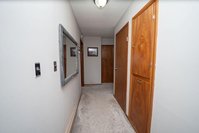 hallway with light colored carpet