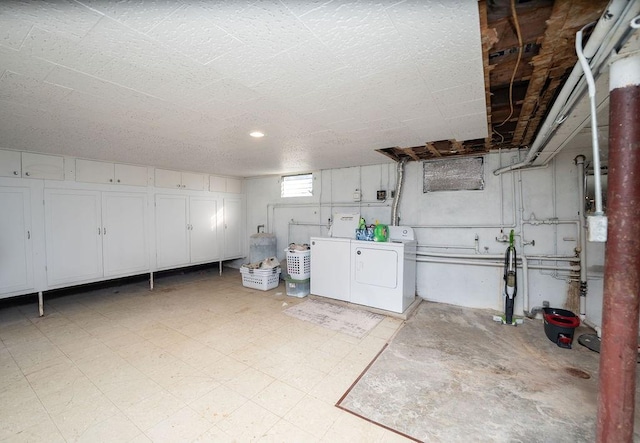 basement with light floors and washer and dryer