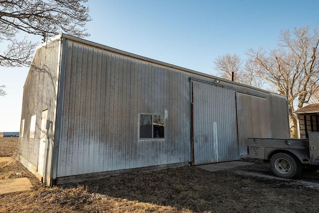 exterior space with a pole building and an outdoor structure