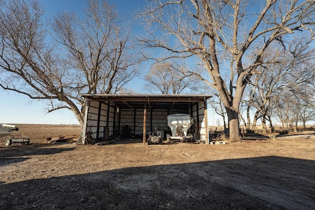 view of pole building featuring driveway and a carport