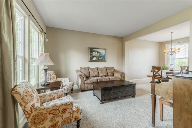 1716 NW 54th Ter, Kansas City, MO 64118 - living room with healthy amount of natural light, carpet, a chandelier, and baseboards
