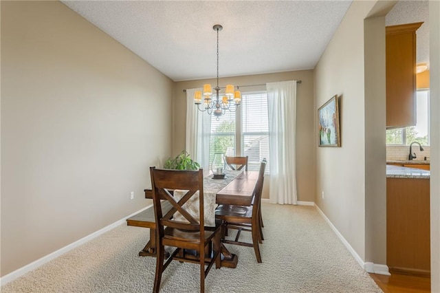 1716 NW 54th Ter, Kansas City, MO 64118 - dining room with a chandelier, baseboards, and light carpet