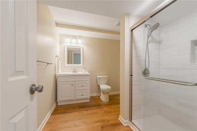 1716 NW 54th Ter, Kansas City, MO 64118 - full bathroom with toilet, a stall shower, wood finished floors, vanity, and baseboards